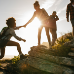 A woman lending a hand to another walker